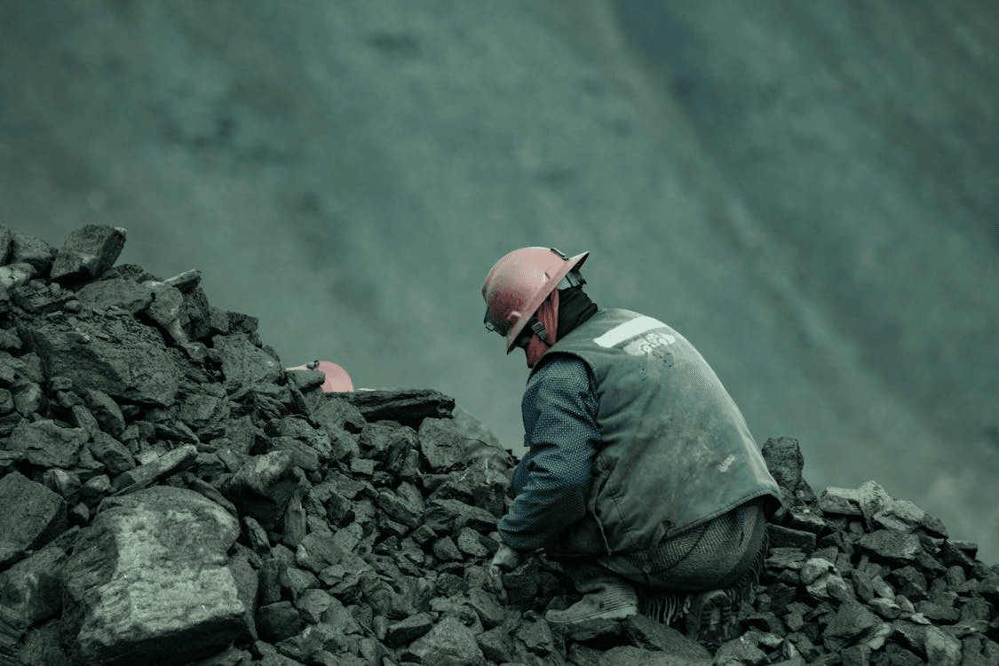 Excavator loading haul truck at mine site